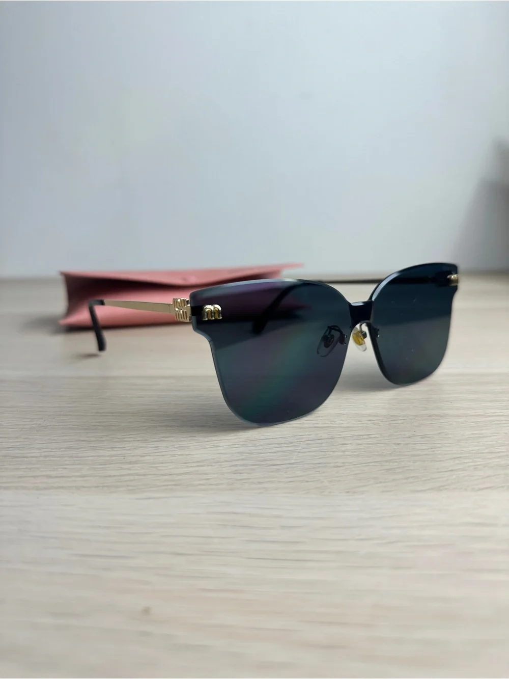 Miu Miu Black and Gold Rimless Sunglasses Miu Miu MU 54YS 5AK5S0 Rimless Wraparound Black Sunglasses - US main image 2